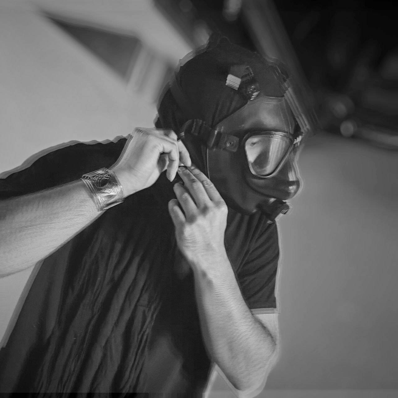 Black-and-White shot of Wayloun's guitarist, seems like a behind the scenes photo yet wearing the mask in an underground with gritty effects